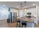 Open concept kitchen with island, stainless steel appliances, and white cabinets at 3923 E Archer Dr, San Tan Valley, AZ 85140