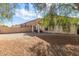 Spacious backyard with gravel and a covered patio area at 43842 W Elizabeth Ave, Maricopa, AZ 85138