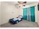 bedroom with a car bed and teal curtains at 43842 W Elizabeth Ave, Maricopa, AZ 85138