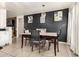 Dining area with a dark-wood table and gray chairs at 43842 W Elizabeth Ave, Maricopa, AZ 85138