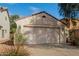 Two-car garage with a light-colored stucco exterior at 43842 W Elizabeth Ave, Maricopa, AZ 85138