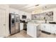 Modern kitchen featuring stainless steel appliances and an island at 43842 W Elizabeth Ave, Maricopa, AZ 85138