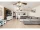 Open living room with a large sectional sofa and TV at 43842 W Elizabeth Ave, Maricopa, AZ 85138