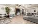Spacious living room with sectional sofa and tile floors at 43842 W Elizabeth Ave, Maricopa, AZ 85138