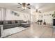 Living room featuring a sectional sofa and ceiling fans at 43842 W Elizabeth Ave, Maricopa, AZ 85138