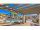 Community pool with pergola, lounge chairs, and cabanas at 5704 E Aire Libre Ave # 1072, Scottsdale, AZ 85254