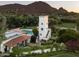 Aerial view of a stunning estate with a tower, pool, and lush landscaping at 5815 N Saguaro Rd, Paradise Valley, AZ 85253