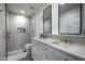 Spa-like bathroom with a walk-in shower, double vanity, and marble tile at 5815 N Saguaro Rd, Paradise Valley, AZ 85253