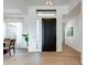 Modern entryway with a sleek black door and wood flooring at 6815 E Amber Sun Dr, Scottsdale, AZ 85266