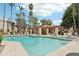 Large community pool with a covered seating area and ample lounge chairs at 9355 N 91St St # 234, Scottsdale, AZ 85258