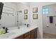 Dual vanity bathroom with modern fixtures and framed artwork at 9622 S 46Th Ln, Laveen, AZ 85339