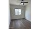 Spacious bedroom with hardwood floors and large window at 9872 W Black Hill Rd, Peoria, AZ 85383