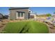 Landscaped front yard with artificial turf and drought-tolerant plants at 9872 W Black Hill Rd, Peoria, AZ 85383