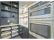 Modern kitchen pantry with dark wood shelving and pull-out drawers at 9872 W Black Hill Rd, Peoria, AZ 85383