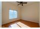 Bright bedroom with wood flooring and ceiling fan at 10225 W Denton Ln, Glendale, AZ 85307