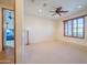 Spacious bedroom with large window and plush carpet at 10575 E Rising Sun Dr, Scottsdale, AZ 85262