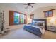 Bright bedroom with large window and plush carpet at 10575 E Rising Sun Dr, Scottsdale, AZ 85262