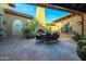 Relaxing courtyard with brick patio, fireplace, and seating area at 10575 E Rising Sun Dr, Scottsdale, AZ 85262
