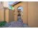Inviting entryway with arched doorway and brick walkway at 10575 E Rising Sun Dr, Scottsdale, AZ 85262