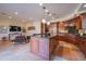 Gourmet kitchen with large island, granite counters, and wood cabinetry at 10575 E Rising Sun Dr, Scottsdale, AZ 85262