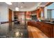 Gourmet kitchen with dark wood cabinetry, granite counters, and high-end appliances at 10575 E Rising Sun Dr, Scottsdale, AZ 85262