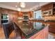 Gourmet kitchen with dark wood cabinetry, granite counters, and high-end appliances at 10575 E Rising Sun Dr, Scottsdale, AZ 85262