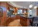 Gourmet kitchen with dark wood cabinetry, granite counters, and high-end appliances at 10575 E Rising Sun Dr, Scottsdale, AZ 85262