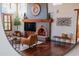 Living room with a brick fireplace and hardwood floors at 10575 E Rising Sun Dr, Scottsdale, AZ 85262