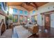 Spacious living room with high ceilings, hardwood floors, and fireplace at 10575 E Rising Sun Dr, Scottsdale, AZ 85262