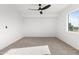 Spacious bedroom with ceiling fan and neutral carpeting at 12737 W Columbine Dr, El Mirage, AZ 85335