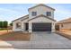 Two-story house with a dark brown garage door and a landscaped yard at 12737 W Columbine Dr, El Mirage, AZ 85335