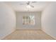 Well-lit bedroom with neutral carpeting and window shutters at 13703 W Pavillion Dr, Sun City West, AZ 85375