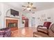 Living room with fireplace and view to kitchen at 13703 W Pavillion Dr, Sun City West, AZ 85375