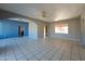 Living room with tiled floors, arched doorways, and a ceiling fan at 1410 E Almeria Rd, Phoenix, AZ 85006