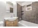 Bathroom with tub, sink, and dark tile surround at 1465 E 2Nd Ave, Mesa, AZ 85204