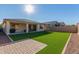 Artificial turf, covered patio, and brick pavers at 19950 W Heatherbrae Dr, Litchfield Park, AZ 85340