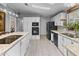 Spacious kitchen featuring an island, white cabinets, and black appliances at 215 N Power Rd # 361, Mesa, AZ 85205