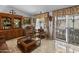 Living room featuring wood furniture, a large window, and patio access at 215 N Power Rd # 361, Mesa, AZ 85205