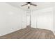 Bedroom with carpet, ceiling fan, closet doors, and hallway access at 21869 W Mohave St, Buckeye, AZ 85326