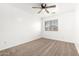 Bedroom with carpet, ceiling fan, and large window at 21869 W Mohave St, Buckeye, AZ 85326
