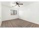 Empty bedroom with carpeting, ceiling fan, and window with blinds at 21869 W Mohave St, Buckeye, AZ 85326