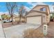 Tan two-story home with attached two-car garage and desert landscaping at 21869 W Mohave St, Buckeye, AZ 85326