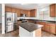 Kitchen boasts stainless steel appliances, ample counter space, and wood cabinetry at 21869 W Mohave St, Buckeye, AZ 85326