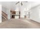 Spacious living room open to the kitchen with carpeted floors and ceiling fan at 21869 W Mohave St, Buckeye, AZ 85326