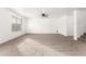 Bright, spacious living room with plush carpet and ceiling fan at 21869 W Mohave St, Buckeye, AZ 85326