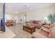 Living room with tiled floors, a brown couch, and a coffee table at 22405 N 148Th Ave, Sun City West, AZ 85375