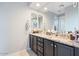 Double vanity bathroom with granite countertop and modern dark cabinets at 22918 E Marsh Rd, Queen Creek, AZ 85142