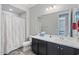 Clean bathroom with dark vanity and a shower/tub combo at 22918 E Marsh Rd, Queen Creek, AZ 85142