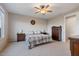 Spacious bedroom with large window, ceiling fan, and ample dresser space at 22918 E Marsh Rd, Queen Creek, AZ 85142