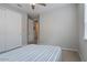 Spacious bedroom with a large bed and double door closet at 22918 E Marsh Rd, Queen Creek, AZ 85142